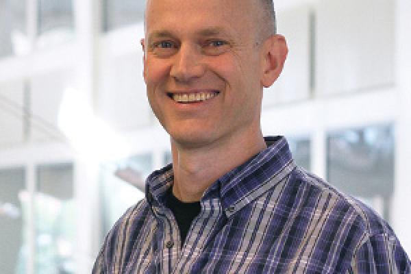 John Beacom smiling with PRB Atrium in the background