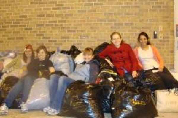 A picture of members of Graduate Women in Physics at The Ohio State University with bags full of charity donations.