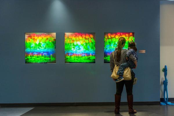 Woman looking at holograms by Betsy Connors