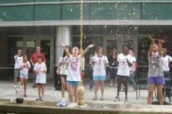 GRASP students doing experiment with soda on the patio of Physics Research Building