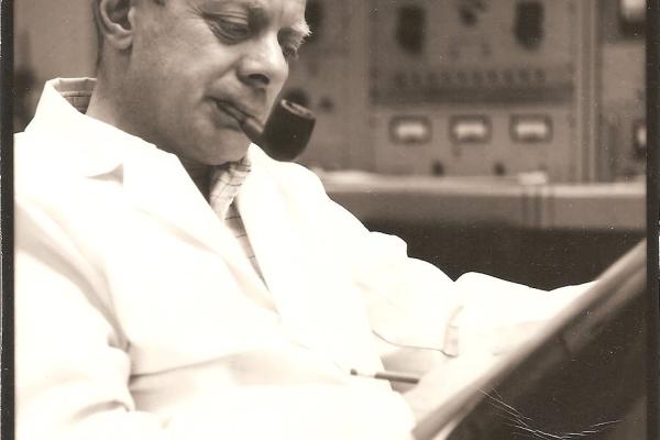 Hersh Hausman reading and smoking a pipe