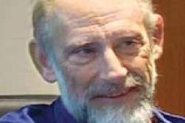 Leonard Susskind smiling and looking off to the side