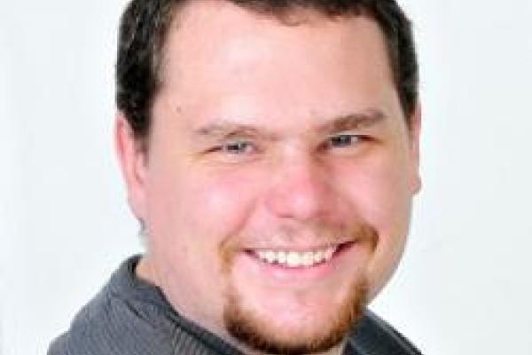 Nicholas Pike smiling with white background