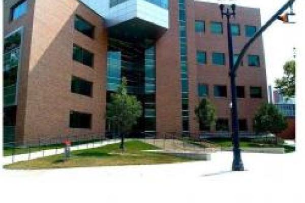 A picture of the exterior of the Physics Research Building at The Ohio State University, a multi-story brick building with large windows and a glass entrance.