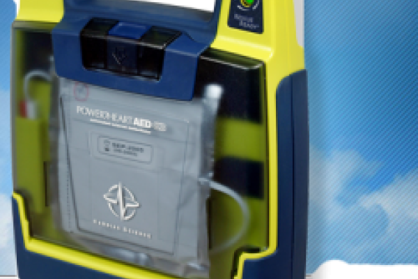 Clip art of yellow and blue AED with sky in the background