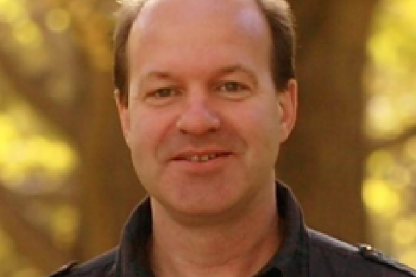 Ron Jansen with yellow trees in the background