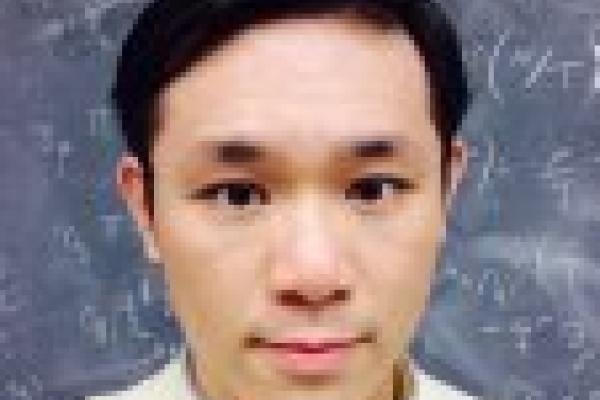 Chun Shen in front of chalkboard