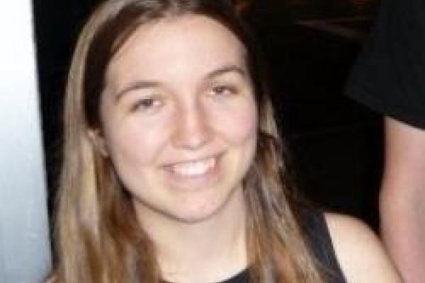 Annika Peter smiling with dark background