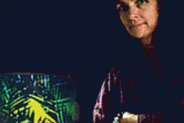 Photo of scientist with black background and hologram next to her