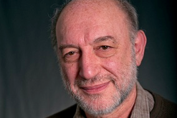 Boris Spivak smiling with grey background