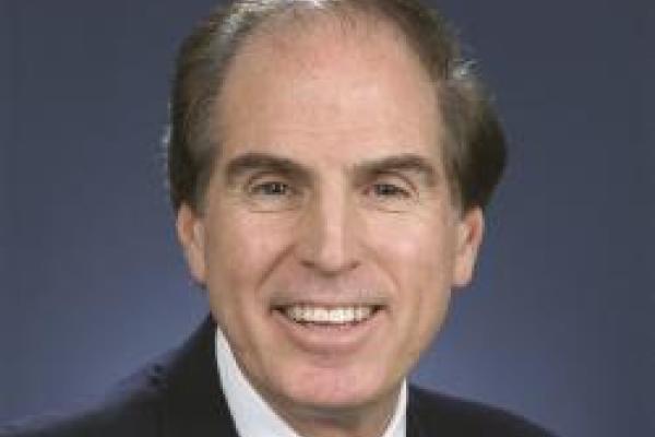 Len Brillson headshot with dark blue background