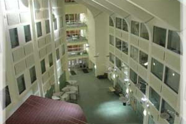The interior of the Physics Research Building atrium. On each wall, there are glass windows to offices.