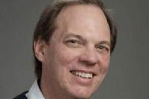 David Hertzog smiling with grey background