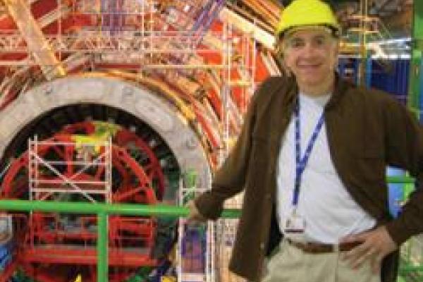 Joe Incandela standing in front of large CERN machinery