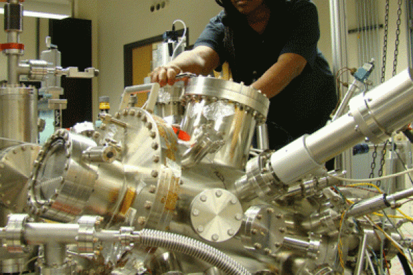 Njoki Mwangi working on machinery in the lab