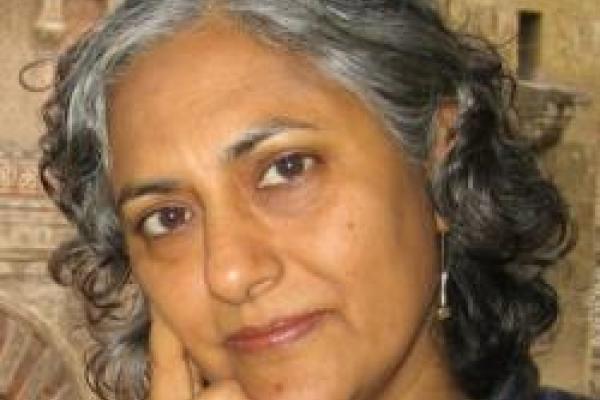 Nandini Trivedi close up with painting behind her