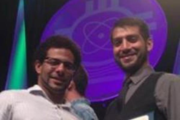 Two students smiling and holding certificates