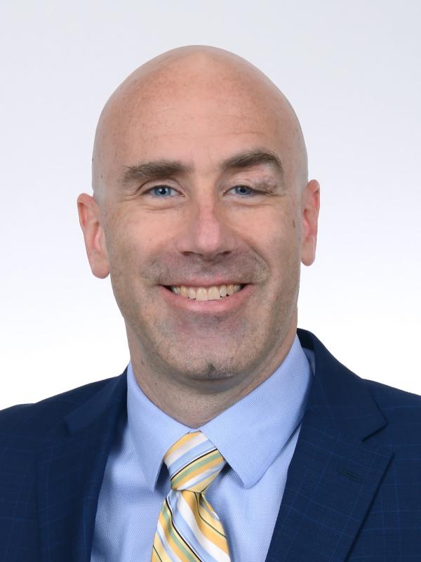 Headshot of Michael Poirier smiling with plain white background