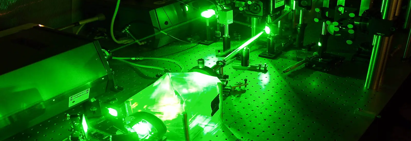 Machine in a dark room glowing bright green