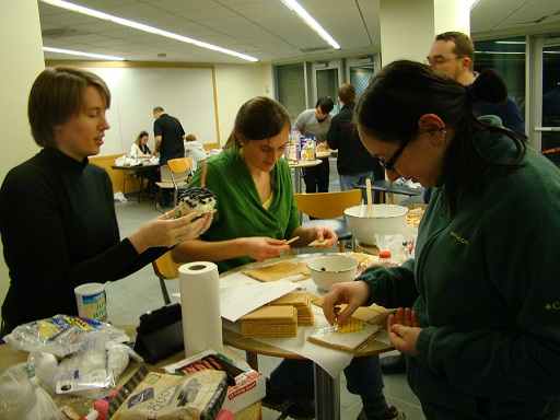 Students building gingerbread houses.